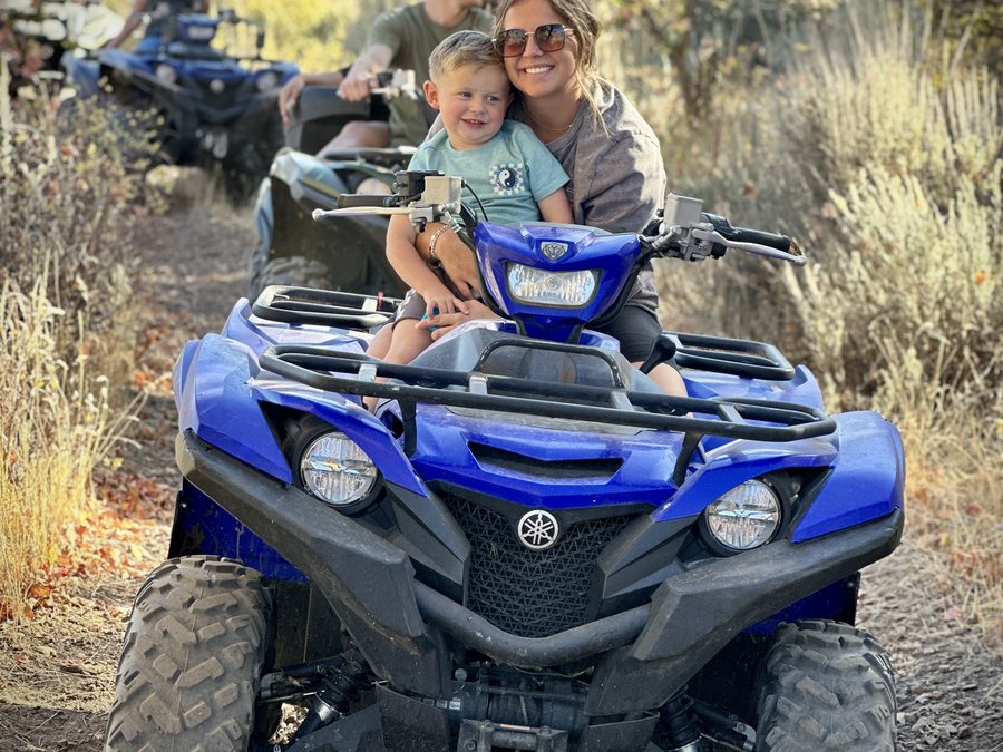 Family riding a Yamaha ATV on a Cache Valley trail
