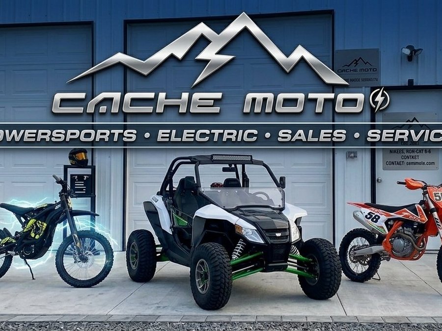 The Cache Moto shop lit up at dusk with machines lined up out front