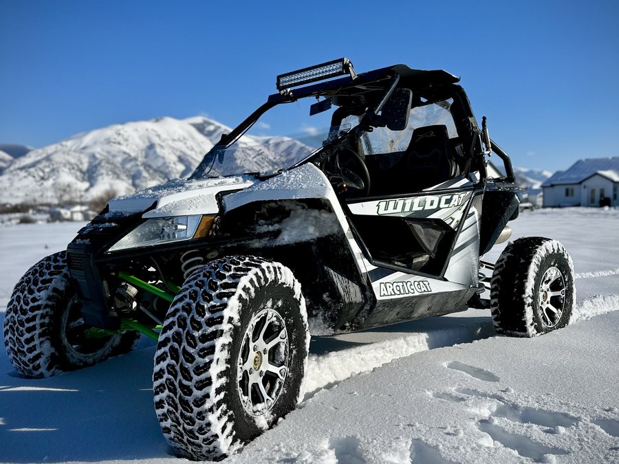 Arctic Cat Wildcat side-by-side parked in fresh snow