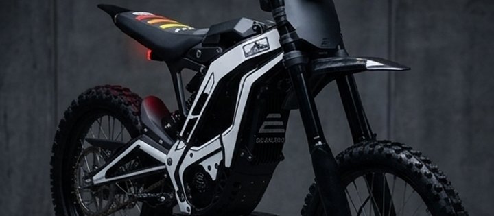 Electric off-road bike with a custom white graphics kit fitted at Cache Moto