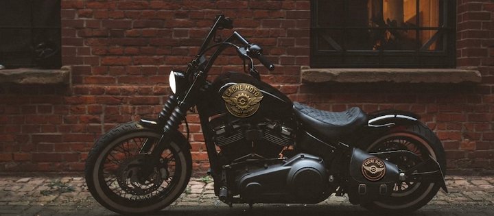 Blacked-out cruiser motorcycle parked outside